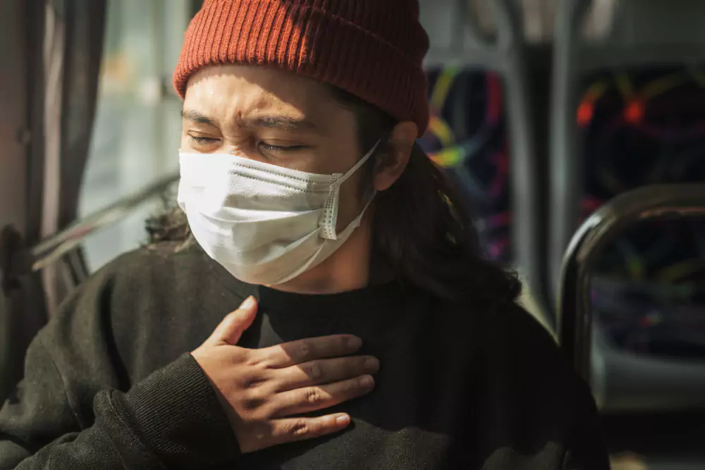 Man With Mask Suffering Chest Pain