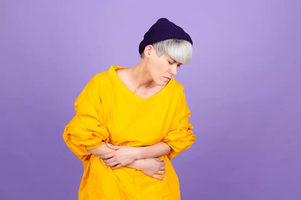 Man With Yellow Shirt Suffering Stomachache